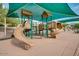 Community playground with slides and climbing structures, covered by a shade awning at 9442 N 118Th St, Scottsdale, AZ 85259