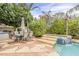 Beautiful pool area with stone patio, spa, patio dining, and lush landscaping at 9442 N 118Th St, Scottsdale, AZ 85259