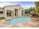 Backyard with a sparkling pool featuring a waterfall, and a manicured lawn, creating a perfect outdoor retreat at 9442 N 118Th St, Scottsdale, AZ 85259