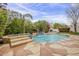 Inviting pool area surrounded by lush landscaping and a tranquil water feature at 9442 N 118Th St, Scottsdale, AZ 85259