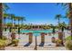 Resort-style pool area with palm trees, manicured landscaping, stone accents and a covered lounge area at 9442 N 118Th St, Scottsdale, AZ 85259