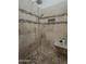 Shower with detailed tile work, rainfall showerhead, a small bench and convenient niche at 9442 N 118Th St, Scottsdale, AZ 85259
