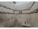 Shower with detailed tile work, rainfall showerhead and convenient niche for storing toiletries at 9442 N 118Th St, Scottsdale, AZ 85259