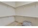 Large walk-in closet with built-in shelving, ample storage space and tile floors at 9442 N 118Th St, Scottsdale, AZ 85259