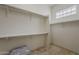 A spacious walk-in closet features built-in shelving and bright natural light at 9442 N 118Th St, Scottsdale, AZ 85259