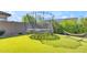 Green backyard with a trampoline, privacy wall, hammock, and mature landscaping at 9942 E Rotation Dr, Mesa, AZ 85212