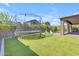 The spacious backyard has artificial turf, a trampoline, a pool, and privacy landscaping at 9942 E Rotation Dr, Mesa, AZ 85212