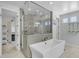 Bright bathroom boasts a soaking tub, glass shower, and serene decor at 9942 E Rotation Dr, Mesa, AZ 85212