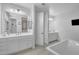 Bright primary bathroom features double vanity, soaking tub and walk-in shower at 9942 E Rotation Dr, Mesa, AZ 85212