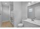 Clean bathroom featuring a vanity, toilet, and shower with floral curtain and wood-look floors at 9942 E Rotation Dr, Mesa, AZ 85212