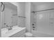 Bright bathroom features a white vanity with sink, toilet and tub with shower at 9942 E Rotation Dr, Mesa, AZ 85212