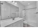Bright bathroom features a white vanity with sink, toilet and tub with shower at 9942 E Rotation Dr, Mesa, AZ 85212