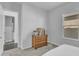 Bright bedroom with adjacent bathroom features neutral carpet and a window at 9942 E Rotation Dr, Mesa, AZ 85212