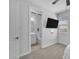 Bedroom featuring an en-suite bathroom and neutral tones, plus a ceiling fan and a TV at 9942 E Rotation Dr, Mesa, AZ 85212