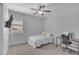 Cozy bedroom with neutral tones, a twin bed, ceiling fan, and desk area at 9942 E Rotation Dr, Mesa, AZ 85212
