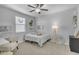Bedroom with a comfortable bed, ceiling fan, natural light and cozy reading nook at 9942 E Rotation Dr, Mesa, AZ 85212