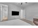 Bright bedroom features a ceiling fan, neutral carpet, and a bed with white covers at 9942 E Rotation Dr, Mesa, AZ 85212