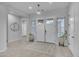 Bright foyer featuring wood-look tile, a round mirror, and a double-door entryway at 9942 E Rotation Dr, Mesa, AZ 85212