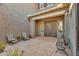 This front yard has a courtyard with chairs, bench, and an ornate iron front door at 9942 E Rotation Dr, Mesa, AZ 85212
