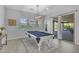 This game room offers a pool table, stylish lighting, and an easy flow to the outdoor living areas at 9942 E Rotation Dr, Mesa, AZ 85212
