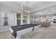 Spacious game room featuring a pool table and an easy flow to the kitchen and outdoor living areas at 9942 E Rotation Dr, Mesa, AZ 85212
