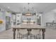 Well-designed kitchen featuring a large center island, modern lighting, and stainless steel appliances at 9942 E Rotation Dr, Mesa, AZ 85212
