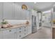 Light and bright kitchen features plentiful white cabinetry and stainless-steel appliances at 9942 E Rotation Dr, Mesa, AZ 85212