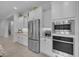 This stylish kitchen features stainless steel appliances and crisp white cabinetry and countertops at 9942 E Rotation Dr, Mesa, AZ 85212