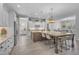 Spacious kitchen featuring bright cabinetry, stainless appliances, large island, and seamless access to pool table area at 9942 E Rotation Dr, Mesa, AZ 85212