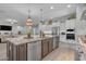Gourmet kitchen with a large center island, granite counters, stainless appliances, and open floor plan at 9942 E Rotation Dr, Mesa, AZ 85212