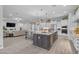 Gourmet kitchen with a large center island, granite counters, stainless appliances, and open floor plan at 9942 E Rotation Dr, Mesa, AZ 85212