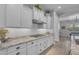 The bright kitchen features white cabinets and drawers plus sleek stainless steel appliances and marble countertops at 9942 E Rotation Dr, Mesa, AZ 85212