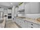 The bright kitchen has ample white cabinetry and countertops as well as modern appliances at 9942 E Rotation Dr, Mesa, AZ 85212