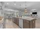 This open kitchen has stainless steel appliances, a large island, and seamless access to living and game areas at 9942 E Rotation Dr, Mesa, AZ 85212