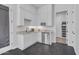 Modern kitchenette with white cabinets, granite countertops, stainless steel appliances, and dark tile flooring at 9942 E Rotation Dr, Mesa, AZ 85212