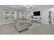 Bright living room with a large sectional sofa, tile floors, and lots of natural light at 9942 E Rotation Dr, Mesa, AZ 85212
