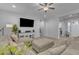 Cozy living room with a large sectional sofa, neutral decor, and a mounted flat screen TV at 9942 E Rotation Dr, Mesa, AZ 85212