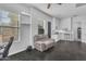 Living room with windows, shelving, comfortable recliner, beverage center, and workstation at 9942 E Rotation Dr, Mesa, AZ 85212