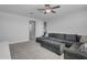 Comfortable living area with a spacious sectional sofa and modern ceiling fan at 9942 E Rotation Dr, Mesa, AZ 85212