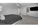 This primary bedroom has plush carpet, ensuite bathroom, and modern ceiling fan at 9942 E Rotation Dr, Mesa, AZ 85212