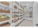Spacious walk-in pantry with ample shelving and stylish wicker basket storage to keep your items organized at 9942 E Rotation Dr, Mesa, AZ 85212