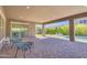 Covered patio features brick pavers, outdoor seating, and a backyard pool, perfect for relaxation and entertaining at 9942 E Rotation Dr, Mesa, AZ 85212