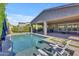 Sparkling pool with travertine deck and lounge chairs, perfect for outdoor relaxation at 9942 E Rotation Dr, Mesa, AZ 85212