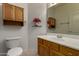 Bathroom with single sink, mirror, and wood cabinet at 1101 S Hazel St, Gilbert, AZ 85296