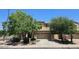 Well-maintained two-story home featuring a two-car garage and a driveway, surrounded by lush landscaping and blue sky at 1101 S Hazel St, Gilbert, AZ 85296