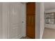 Hallway featuring a door and a wooden storage cabinet near a window at 1101 S Hazel St, Gilbert, AZ 85296