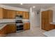 Kitchen with stainless steel appliances, granite countertops, and wooden cabinets for ample storage and easy organization at 1101 S Hazel St, Gilbert, AZ 85296