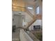 Bright living room features a soaring ceiling, wooden staircase, and a comfortable white sofa at 1101 S Hazel St, Gilbert, AZ 85296
