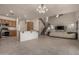 Open-concept design with a modern kitchen featuring stainless steel appliances, a staircase, a living room, and tile flooring at 1101 S Hazel St, Gilbert, AZ 85296