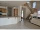 View from kitchen area of the living room with staircase, tiled floor, and comfortable sofa at 1101 S Hazel St, Gilbert, AZ 85296